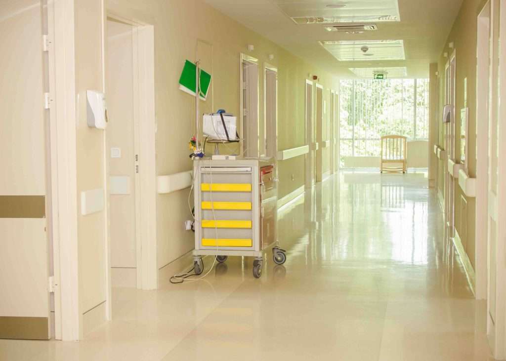 Defibrillator cart prepared for emergency in hospital corridor